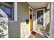 Inviting covered porch showcasing a vibrant yellow door, complemented by white trim and a stylish mail box at 1422 Carrollton Ave, Indianapolis, IN 46202