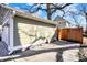 Exterior view of the home's garage and driveway with a wooden fence for privacy at 1422 Carrollton Ave, Indianapolis, IN 46202