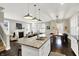 Open-concept kitchen featuring granite countertops, stainless steel appliances, and modern pendant lighting at 1422 Carrollton Ave, Indianapolis, IN 46202