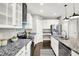 Modern kitchen features stainless steel appliances, a center island with seating, and granite countertops at 1422 Carrollton Ave, Indianapolis, IN 46202