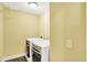 Bright laundry room features tile flooring and modern, front-load washer and dryer appliances at 1422 Carrollton Ave, Indianapolis, IN 46202