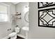 Stylish powder room features modern fixtures and a decorative mirror creating an elegant space for guests at 1422 Carrollton Ave, Indianapolis, IN 46202