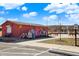 Exterior view of a colorful restroom building, with benches, near a splash pad area at 1422 Carrollton Ave, Indianapolis, IN 46202