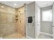 Shower enclosed with glass features tiled surround and a niche for toiletries at 1422 Carrollton Ave, Indianapolis, IN 46202