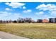 A soccer field with soccer goals sits in front of new construction and a partly cloudy blue sky at 1422 Carrollton Ave, Indianapolis, IN 46202