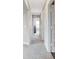 Hallway offers seamless transition with neutral walls, plush carpeting, and doors leading to various rooms in the home at 1439 Bellows Ave, Franklin, IN 46131