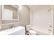 Clean bathroom with white subway tile, white vanity, and combined shower and bathtub at 1611 Elmhurst Dr, Indianapolis, IN 46219