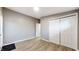 Inviting bedroom featuring hardwood floors, ample closet space, and neutral paint at 1611 Elmhurst Dr, Indianapolis, IN 46219