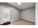 Bright bedroom with hardwood floors, a door to an outdoor deck, and neutral walls at 1611 Elmhurst Dr, Indianapolis, IN 46219