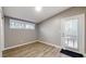 Cozy bedroom with hardwood floors, bright windows, and access to an outdoor deck at 1611 Elmhurst Dr, Indianapolis, IN 46219