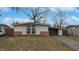 Traditional-style home featuring large window, attached garage, and well-manicured lawn at 1611 Elmhurst Dr, Indianapolis, IN 46219