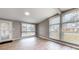 Living area with hardwood floors and large windows allowing plenty of natural light at 1611 Elmhurst Dr, Indianapolis, IN 46219