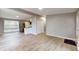 Open-concept living room with hardwood floors and an open view to the kitchen at 1611 Elmhurst Dr, Indianapolis, IN 46219