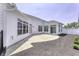 Expansive backyard with a concrete patio and neat mulch beds, complemented by a white picket fence at 16799 Imperial Ct, Fishers, IN 46040