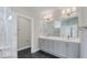 A modern bathroom with double sinks, neutral gray cabinets, and a large mirror at 16799 Imperial Ct, Fishers, IN 46040