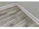 Close up on the flooring of a light gray hardwood floor and molding at 16799 Imperial Ct, Fishers, IN 46040