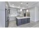 Modern kitchen featuring gray cabinets, stainless steel appliances, a large island and quartz countertops at 16799 Imperial Ct, Fishers, IN 46040