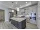 Elegant kitchen features a gray island, stainless appliances, quartz counters and modern pendant lighting at 16799 Imperial Ct, Fishers, IN 46040