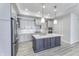 Modern kitchen featuring gray cabinets, stainless steel appliances, a large island and quartz countertops at 16799 Imperial Ct, Fishers, IN 46040