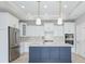 A modern kitchen features stainless steel appliances, marble countertops, and a center island at 16799 Imperial Ct, Fishers, IN 46040