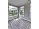 Bright living room featuring hardwood floors and large windows that bring in natural light at 16799 Imperial Ct, Fishers, IN 46040
