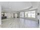 Spacious living room featuring wood floors, fireplace with stone surround, modern lighting and sliding glass doors at 16799 Imperial Ct, Fishers, IN 46040