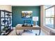 A cozy home office features natural lighting, an accent wall, and comfortable furnishing at 16799 Imperial Ct, Fishers, IN 46040