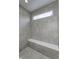 Modern tiled shower with a built-in bench and a sleek, minimalist design at 16799 Imperial Ct, Fishers, IN 46040