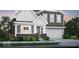 Charming two-story home featuring gray siding, white trim, a brick foundation, and an attached garage at 16942 Sandhurst Pl, Westfield, IN 46074