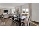 Elegant dining area with large windows, a modern table, and seamless access to the open living space at 16954 Sandhurst Pl, Westfield, IN 46074