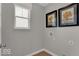 Corner laundry room features natural light and wall art at 16954 Sandhurst Pl, Westfield, IN 46074
