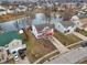 Aerial view of a house with a red roof in a residential community next to a pond at 1750 Quiet Haven Cir, Indianapolis, IN 46229