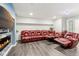Finished basement area with a large sectional, recliner seating, and a decorative fireplace at 1750 Quiet Haven Cir, Indianapolis, IN 46229