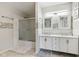 Bright bathroom featuring double sink vanity, stylish tile accents, and a glass-enclosed shower at 1750 Quiet Haven Cir, Indianapolis, IN 46229