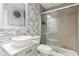 Bathroom featuring modern tiles, a stylish vessel sink, and a glass-enclosed shower at 1750 Quiet Haven Cir, Indianapolis, IN 46229