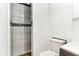 Bathroom featuring tiled shower with decorative accents and a white toilet at 1750 Quiet Haven Cir, Indianapolis, IN 46229