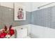 Elegant bathroom with grey tiled accents, a toilet, and decor adding a touch of sophistication at 1750 Quiet Haven Cir, Indianapolis, IN 46229