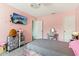 Pink bedroom featuring a tufted headboard, wall-mounted TV, and decorative accents at 1750 Quiet Haven Cir, Indianapolis, IN 46229