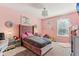 Pink bedroom featuring a tufted headboard, crystal chandelier, and decorative accents at 1750 Quiet Haven Cir, Indianapolis, IN 46229