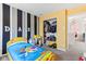 bedroom boasting striped accent wall, closet, and playful decorations at 1750 Quiet Haven Cir, Indianapolis, IN 46229