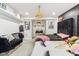 Bedroom with two beds, black accent wall, overhead chandelier, and decorative wall art at 1750 Quiet Haven Cir, Indianapolis, IN 46229