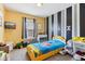 Vibrant bedroom featuring colorful walls, striped accent wall, and plush toys at 1750 Quiet Haven Cir, Indianapolis, IN 46229