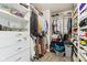 Organized walk-in closet with clothing racks, shoe shelves, and white storage drawers at 1750 Quiet Haven Cir, Indianapolis, IN 46229