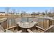 A lakeside deck features a cozy fire pit table with comfortable Adirondack chairs and decorative pillows at 1750 Quiet Haven Cir, Indianapolis, IN 46229