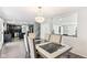 Bright dining room with an elegant chandelier and views of the kitchen and living areas at 1750 Quiet Haven Cir, Indianapolis, IN 46229