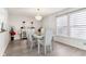 Dining room featuring new vinyl plank flooring, a large window, and modern chandelier at 1750 Quiet Haven Cir, Indianapolis, IN 46229