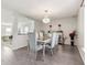 Formal dining area with elegant chandelier, new vinyl plank flooring, and convenient access to living spaces at 1750 Quiet Haven Cir, Indianapolis, IN 46229
