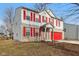 Two-story home boasts great curb appeal with brick and siding exterior, and bright red shutters at 1750 Quiet Haven Cir, Indianapolis, IN 46229