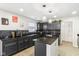 Charming kitchen showcasing dark cabinetry, granite counters, mosaic backsplash, and an island at 1750 Quiet Haven Cir, Indianapolis, IN 46229