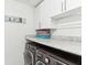 Convenient laundry room with modern washer/dryer units, countertop space, and ample storage cabinets at 1750 Quiet Haven Cir, Indianapolis, IN 46229